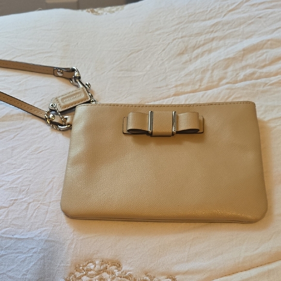 Coach Handbags - Coach Tan Wristlet Clutch with Bow Accent